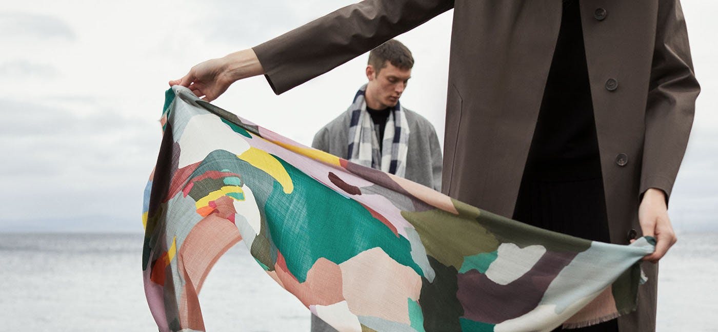 Muli coloured camouflage printed scarf blows in the wind